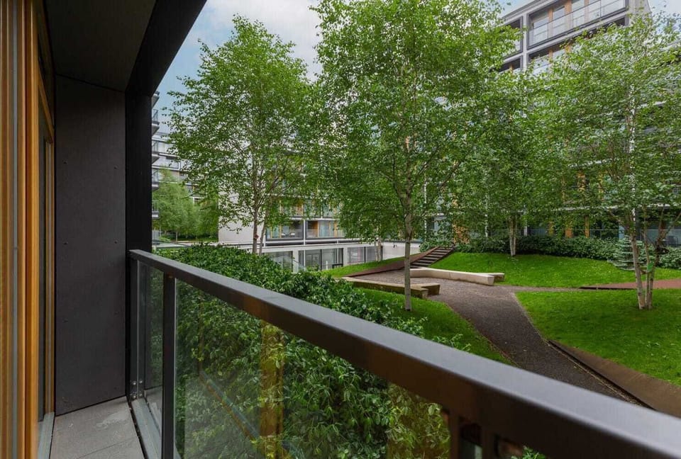 Exterior view of the building courtyard with lush greenery and clean landscaping.

