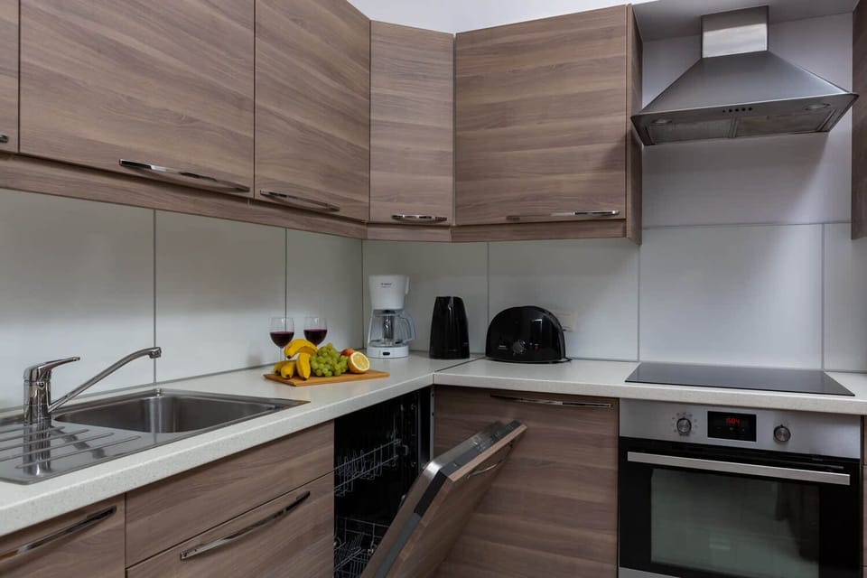 Second view of the modern kitchen area showcasing spacious cabinetry and countertops.
