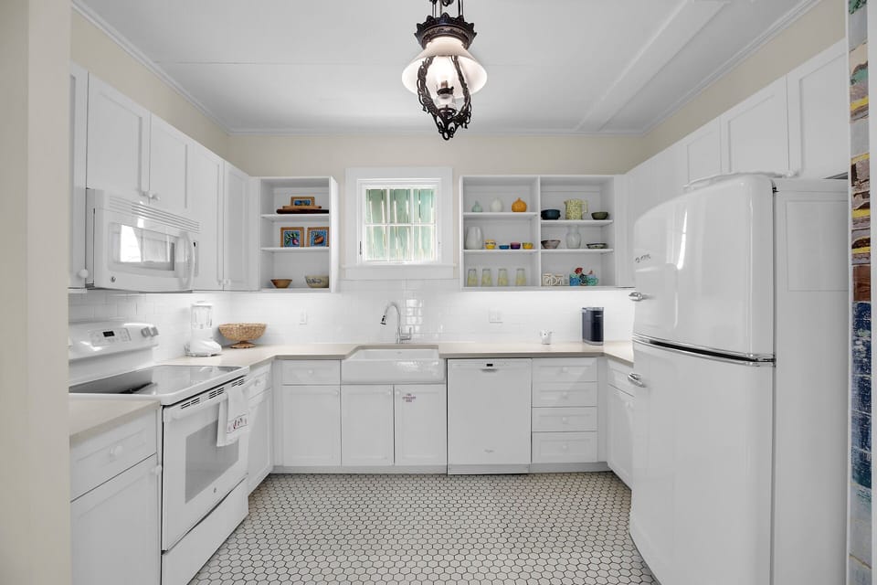 Crisp clean kitchen with retro fridge and plenty of storage!
