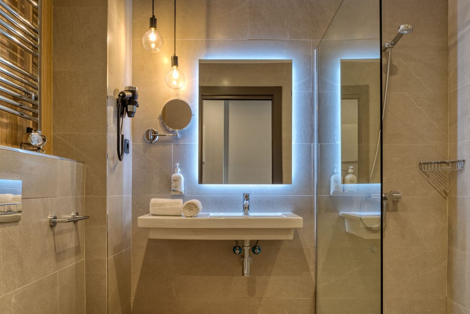 Shower, rainfall showerhead, hair dryer, towels