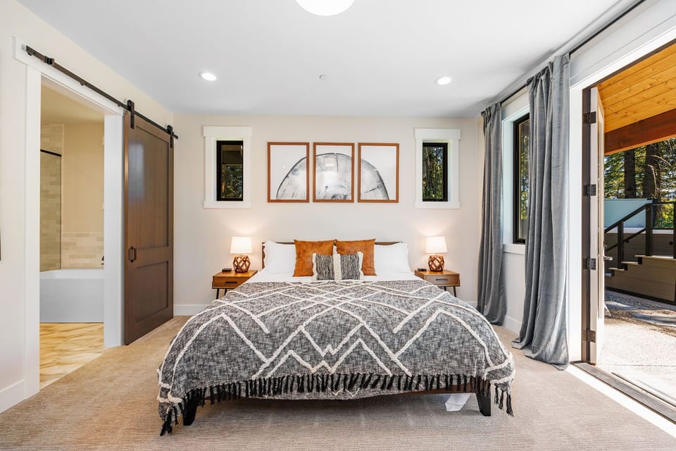 Main Floor - Bedroom 1 – Master Suite King Bed + En Suite Bathroom with barn-door en-suite and direct access to open-air amenities