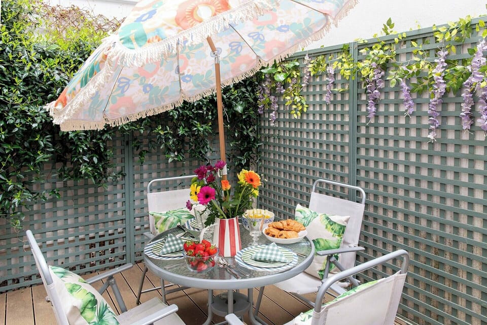 Relax outdoors on the patio with table for dining al fresco.