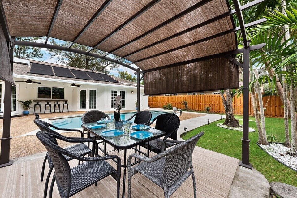 Relax in the private backyard with amazing views day & night and amenities that include a heated pool, outdoor shower, outdoor dining bar, large pergola for shade, outdoor fans, BBQ grill and comfortable dining seating all surrounded by tropical landscaping.