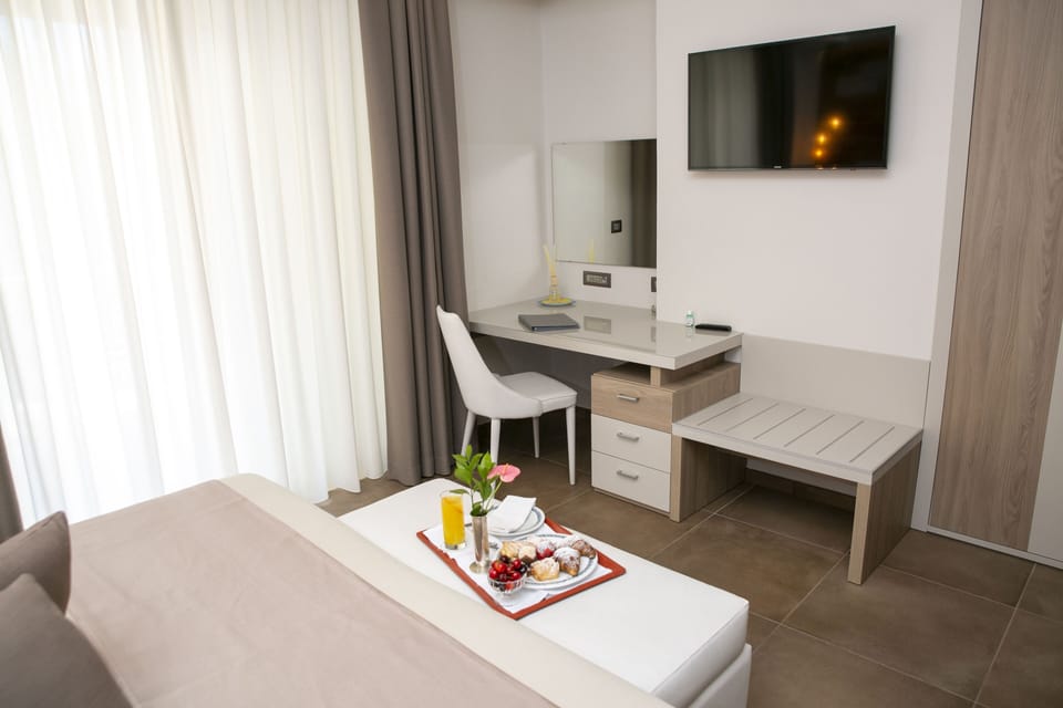 Deluxe Double Room, Balcony, Partial Sea View | Minibar, in-room safe, desk, soundproofing