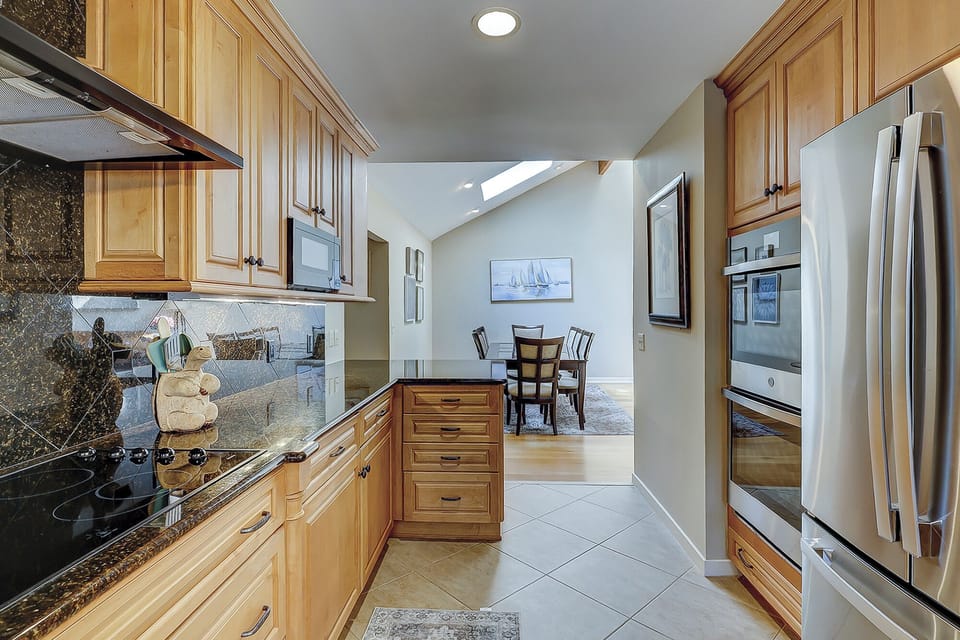 Fully stocked kitchen with 2 barstools for extra seating.