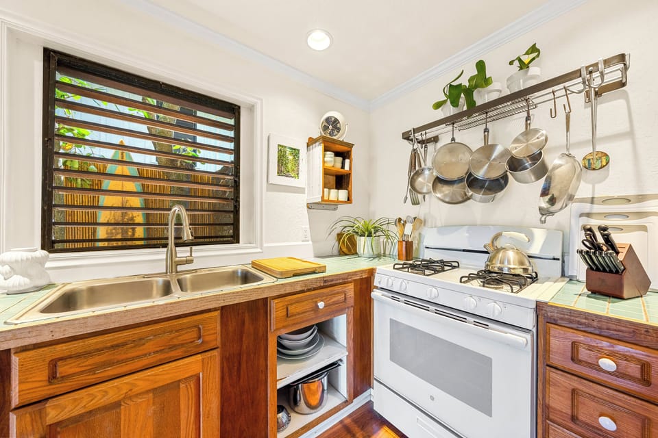 Kitchen features propane stove and All Clad cookware