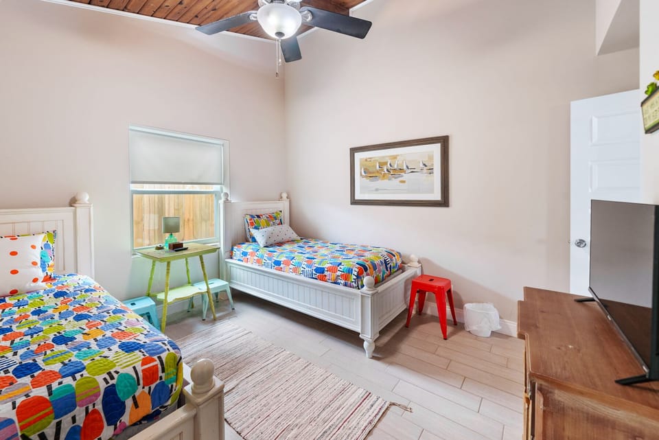 Your kids will love this cheerful twin bedroom with colorful bedding, fun décor, and plenty of space to play and relax together.