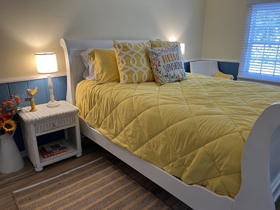 Front bedroom with queen beds, dresser and tv