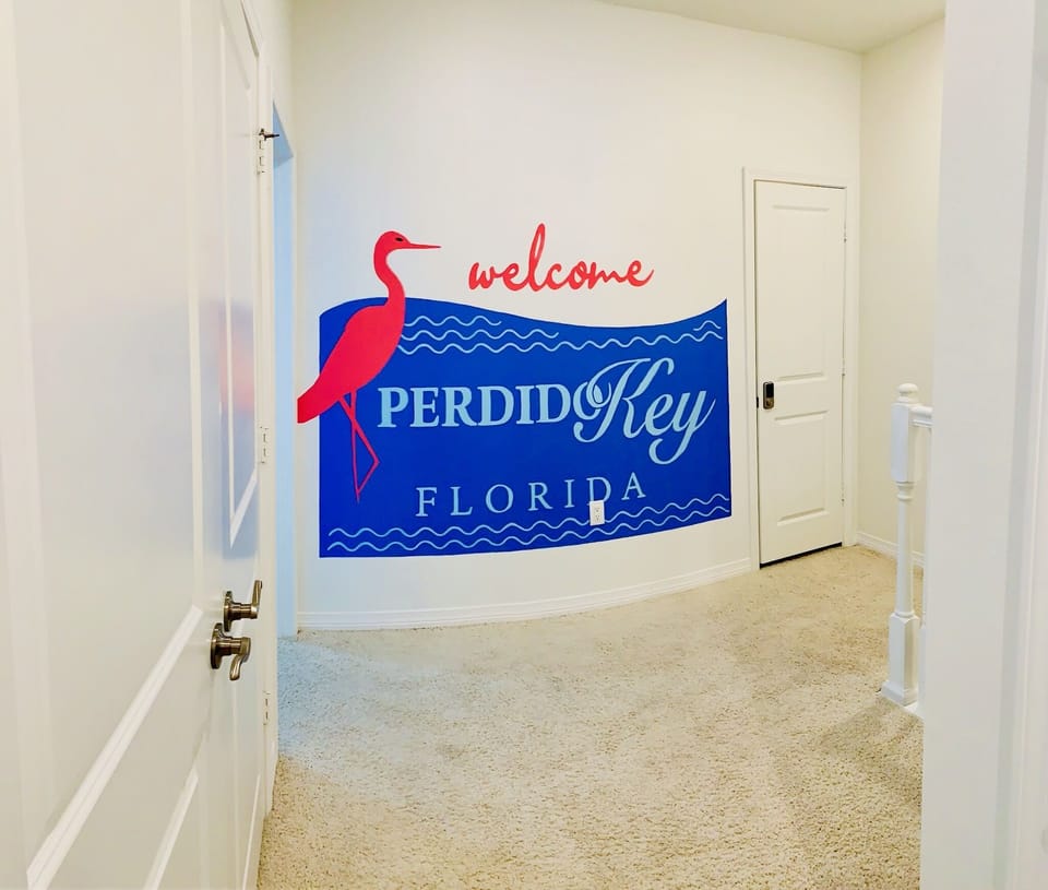 The "Welcome to Perdido Key" replica sign located in between the bedrooms.