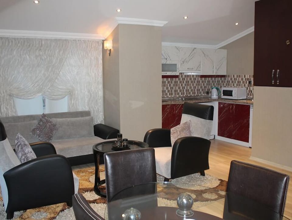 Deluxe Suite, 1 Bedroom | Living room | LCD TV