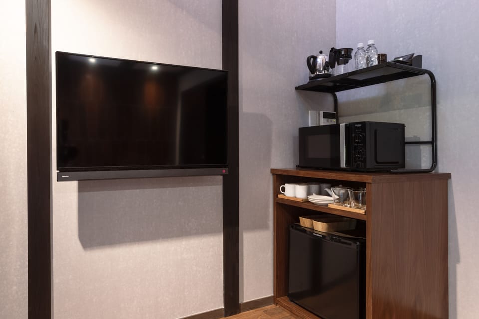 Standard Suite | Living area | 24-inch flat-screen TV with digital channels, TV, heated floors