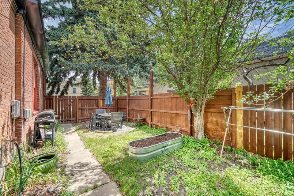 Side Yard with outdoor seating and dining area. 
~Gas Grill