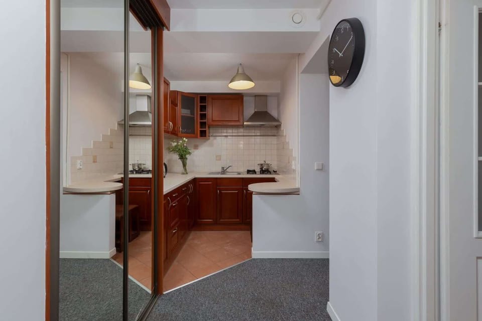 Kitchen with dark cabinets, a countertop, and warm lighting for a cozy feel.
