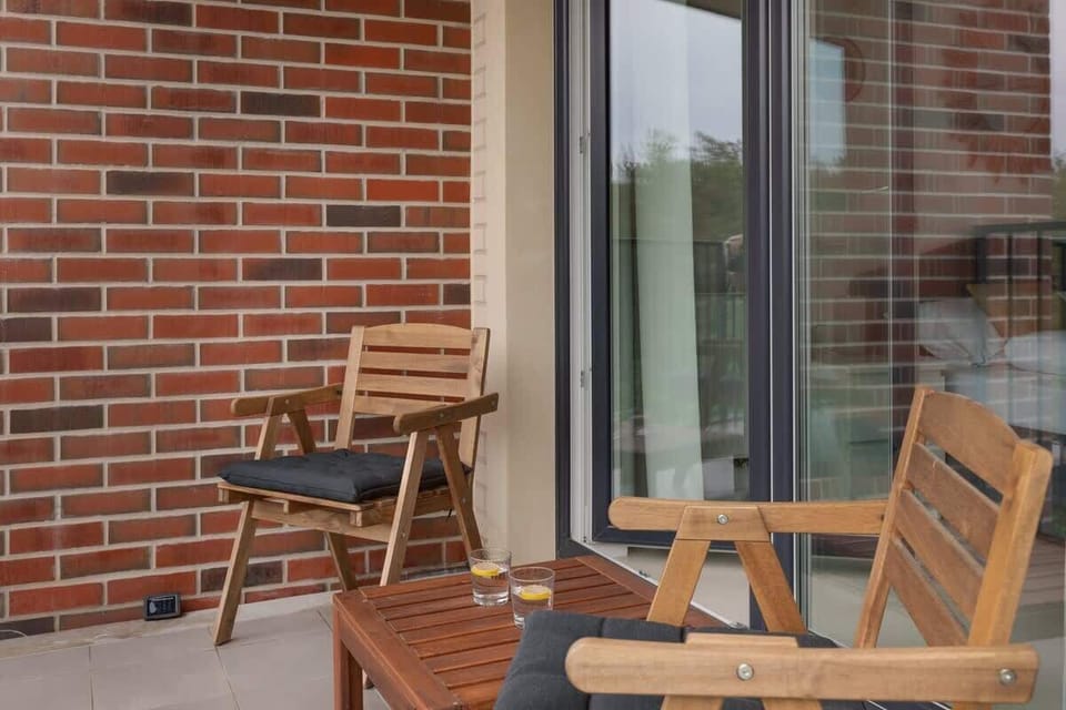 Two comfortable chairs with a small table on the balcony, perfect for enjoying morning coffee or an evening rest.