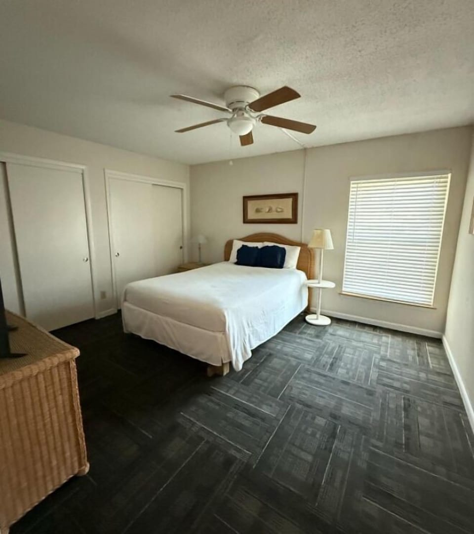 The spacious 2nd floor guest bedroom offers a queen-size bed and a TV, providing a comfortable retreat for relaxation.