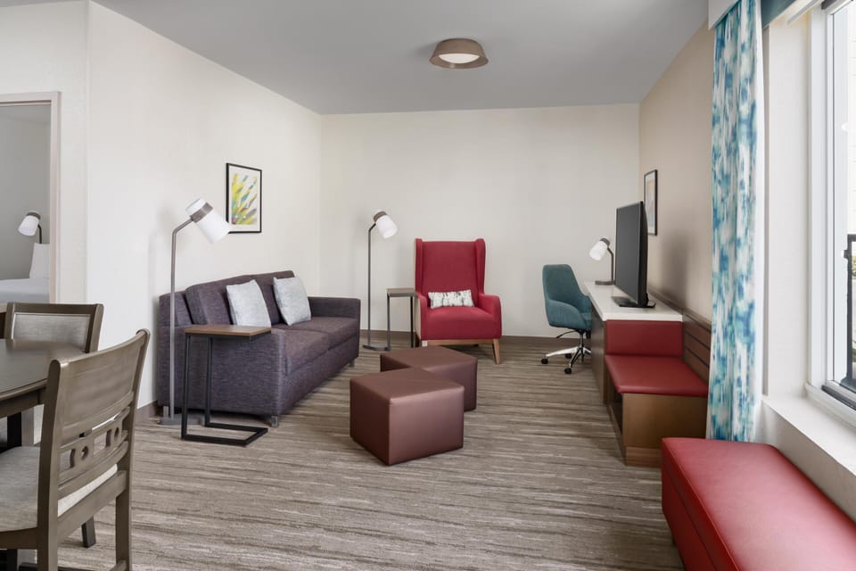 Suite, 1 King Bed | Living area | 55-inch flat-screen TV with cable channels, TV, MP3 dock