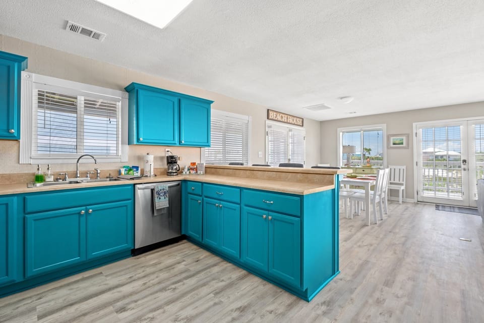 The kitchen flows into a cozy dining area for 6, perfect for meals together
