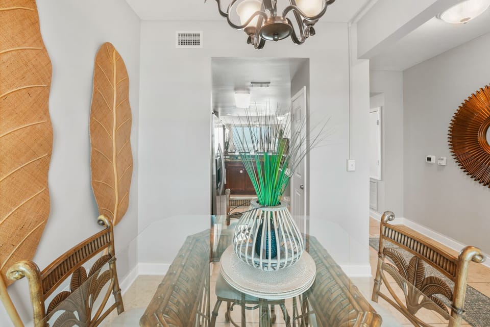 Your elegant dining space features coastal charm with wicker chairs and tropical décor, perfect for memorable meals together.