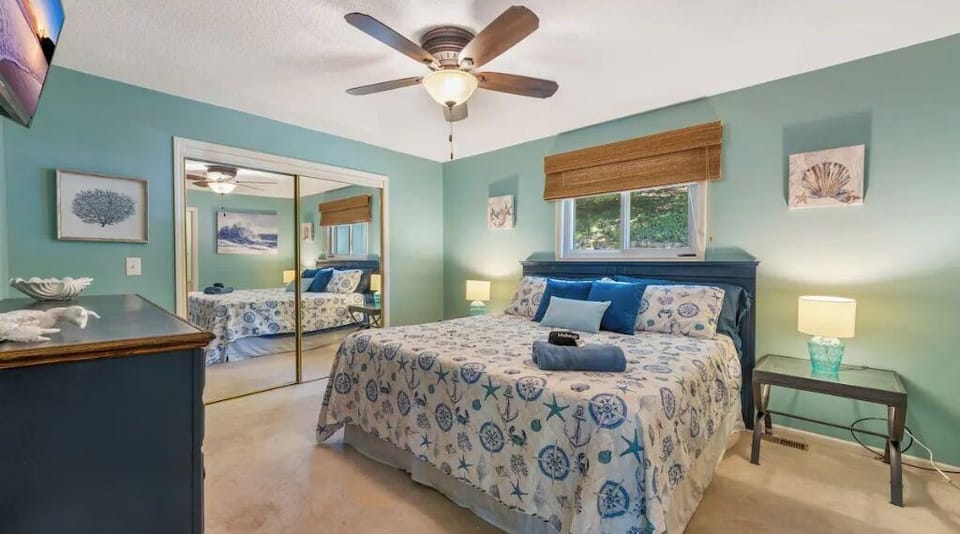 Another view of master bedroom w/ king size bed & attached bathroom, 31'' tv
