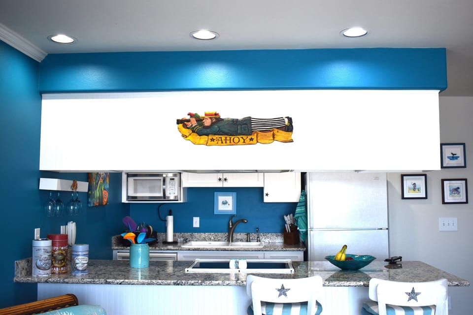 A well stocked kitchen with quartz countertops.
