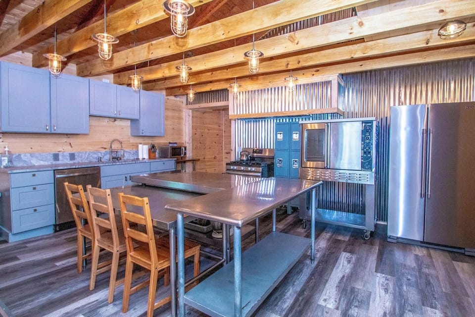 Large kitchen, with commercial oven, gas stove, dishwasher and ample space for group meal prep. 