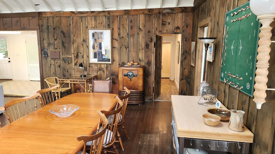 Dining table seating for 8 with serving table and view down the hallway