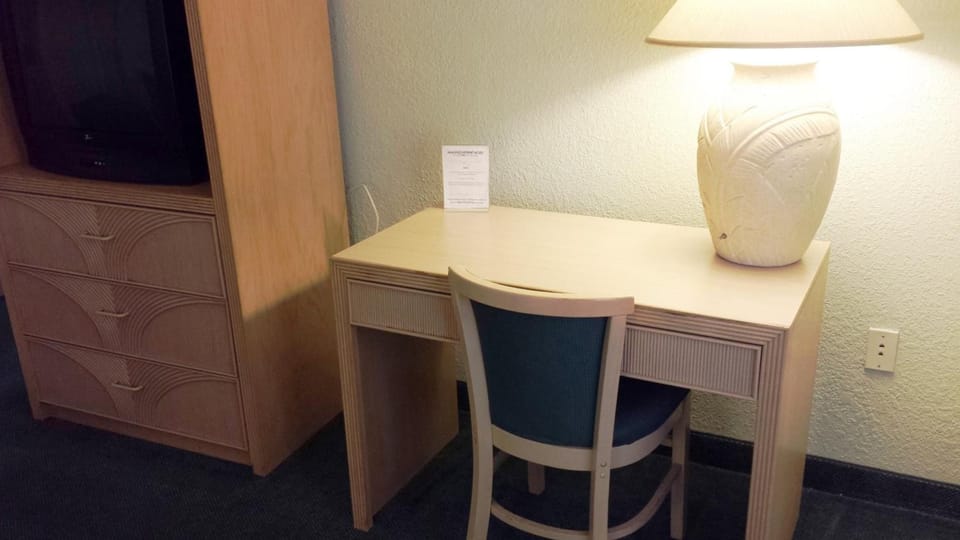 Desk, laptop workspace, blackout drapes, iron/ironing board