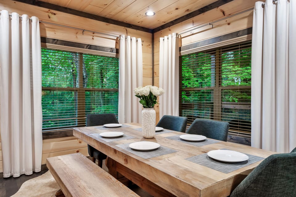 Dining table with seating for 8 and additional seating in the bar area.
