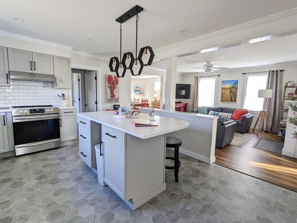 Well-appointed kitchen with island seating, open to living room 
