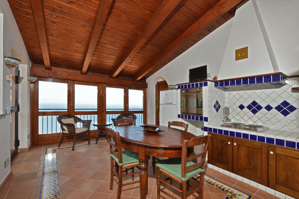 The bright kitchen dinin room with a nice and wide view on the sea
