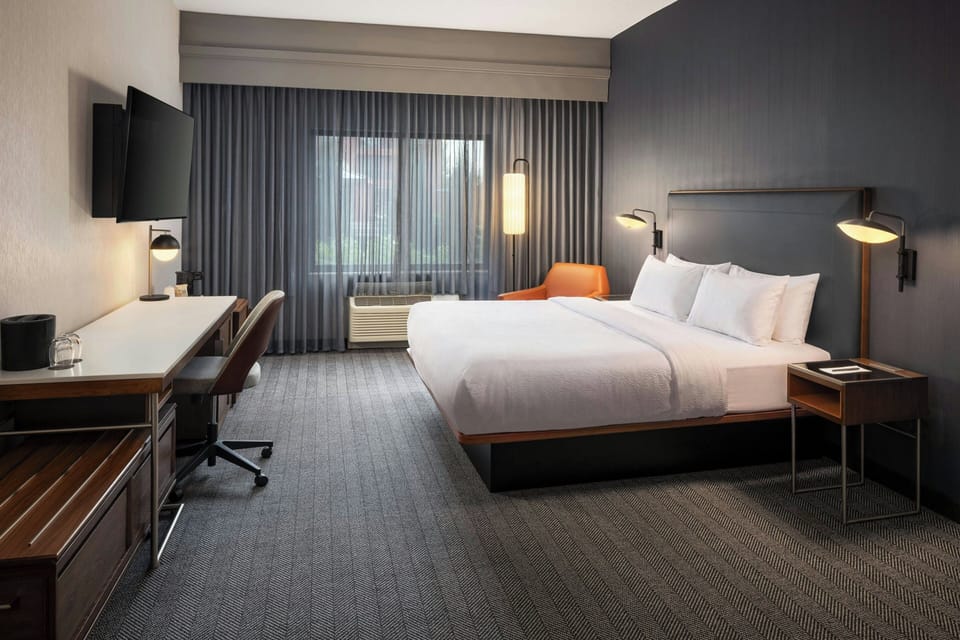 Premium bedding, desk, laptop workspace, blackout drapes