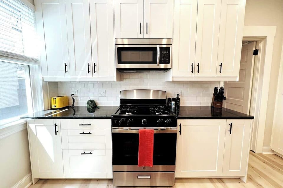 Bright and cheerful kitchen. Nordic Pine Floors. Simple yet luxurious design touches. Gas Range. 