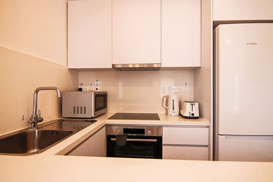 Luxury Apartment | Private kitchen | Fridge, electric kettle, highchair, dining tables