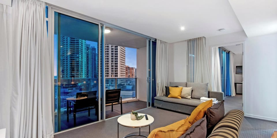 Cozy living room is right next to the balcony overlooking the ocean and the city