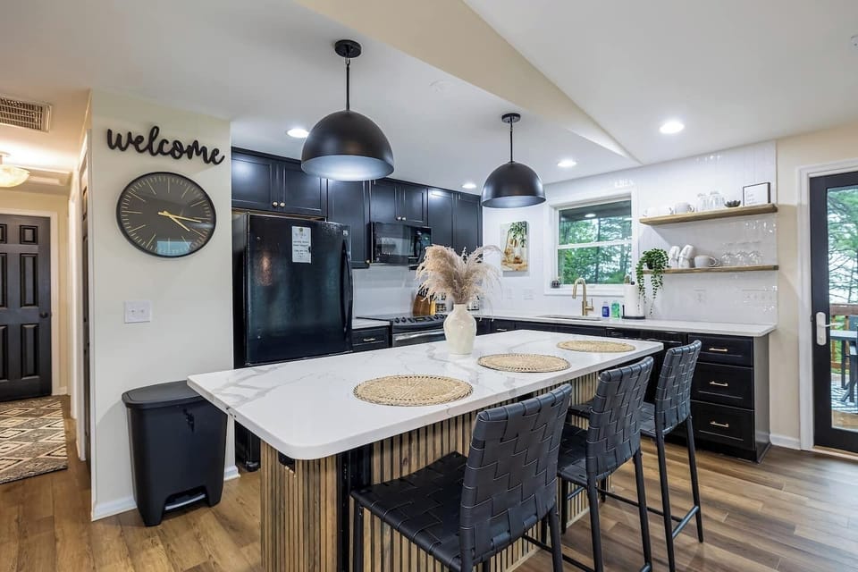 Stylish and open kitchen with Quartz Countertops, tiled backsplash, updated appliances, fully stocked kitchen