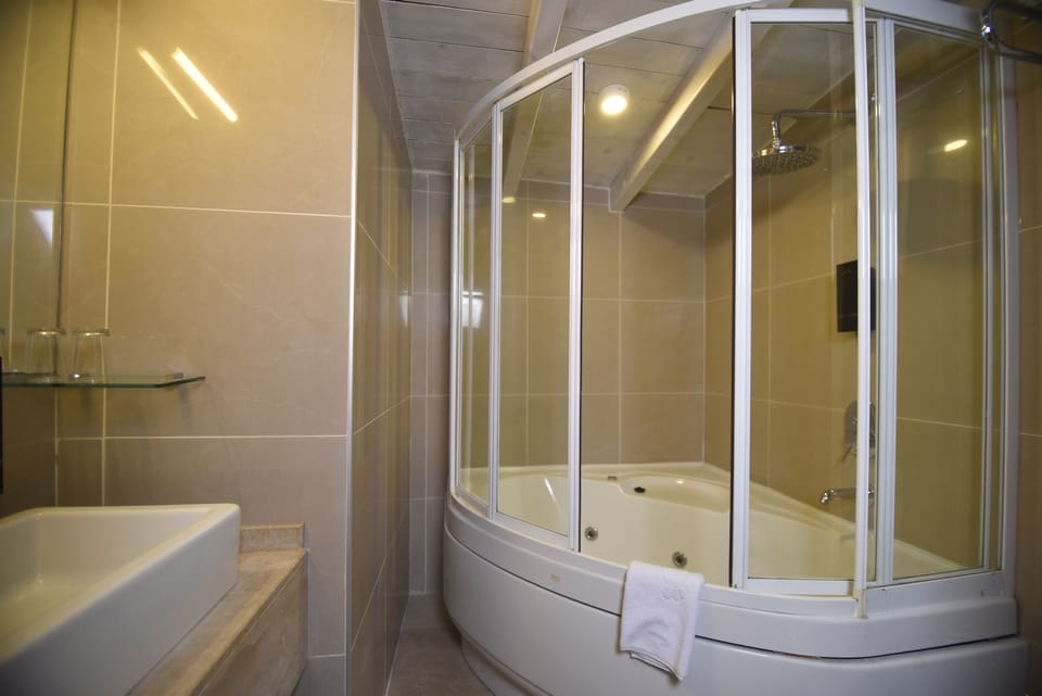 Studio, 1 Bedroom, Non Smoking, City View | Bathroom | Shower, rainfall showerhead, bathrobes, slippers