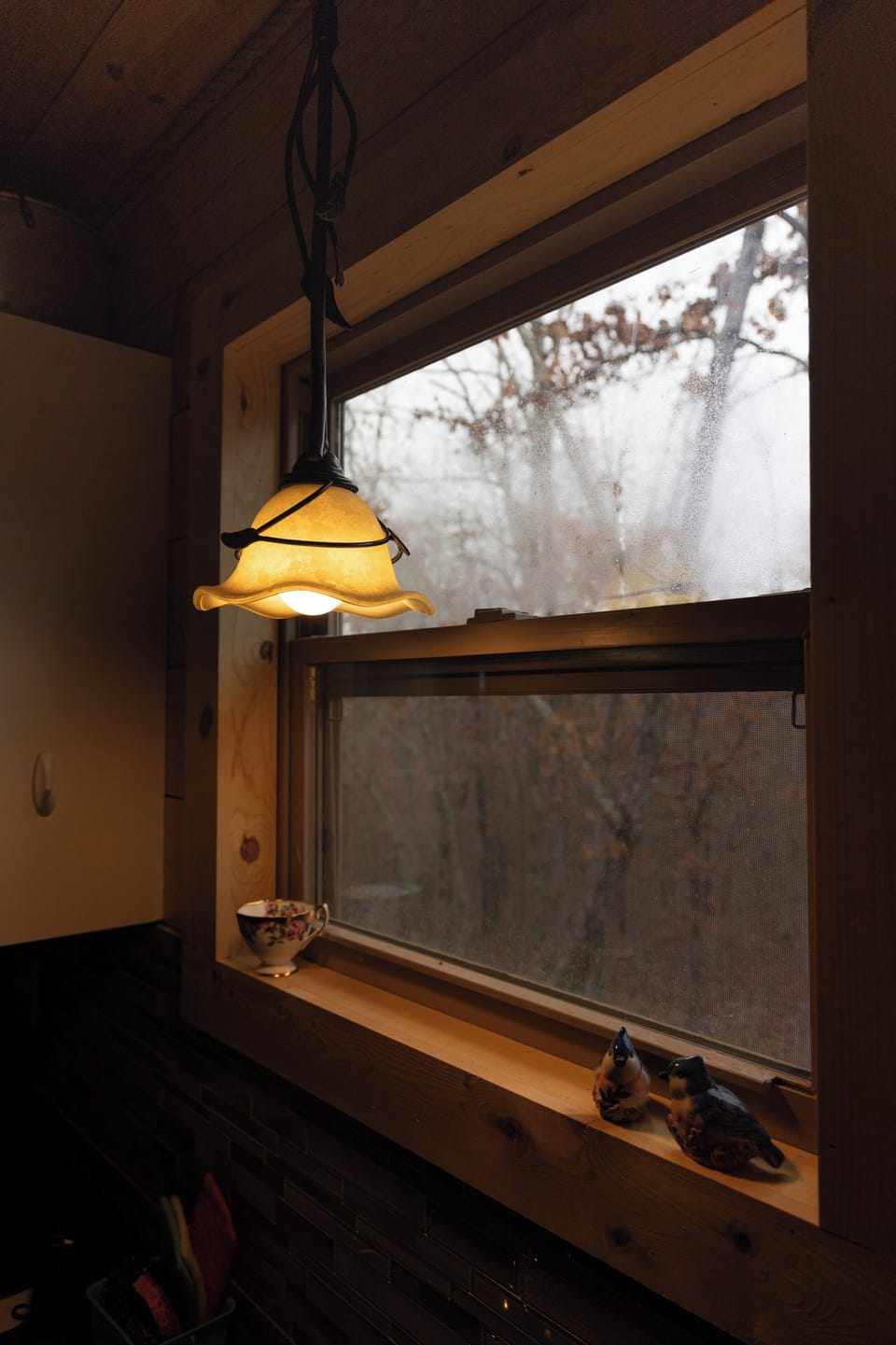 Living Room featuring native wood accents, 6 seat pub table, and private view of the surrounding woods.