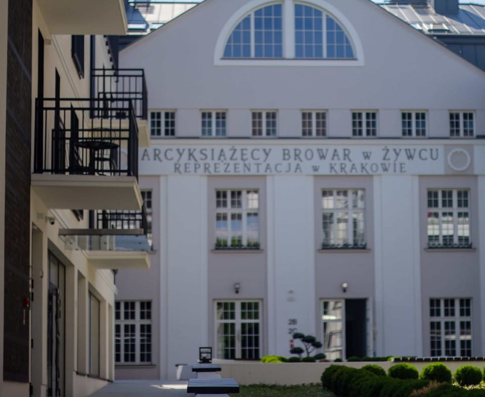 A stylish building exterior with classic architectural detailing, large windows, and a well-maintained courtyard view, giving it a sophisticated and elegant appearance.