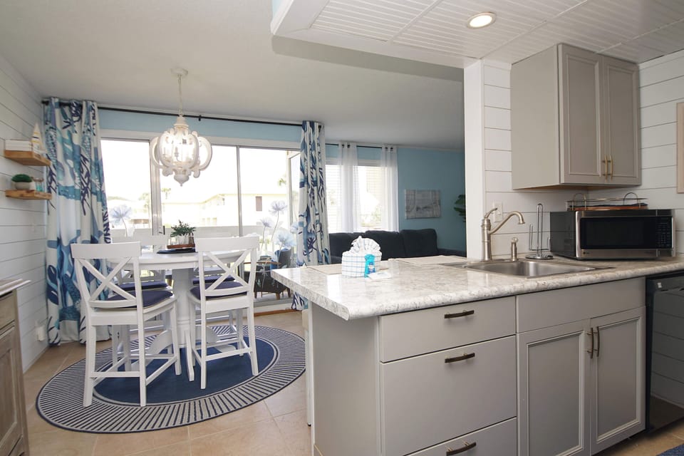 Prepare meals in your bright, fully-equipped kitchen with granite counters and modern appliances, then dine at the cozy table by the window.
