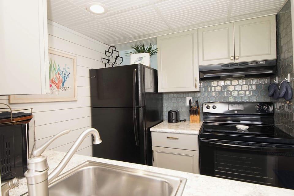 Your fully equipped kitchen awaits with modern appliances, stylish backsplash, and everything needed to create delicious meals during your stay.
