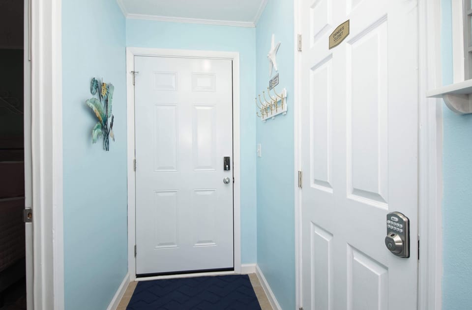 Step into your welcoming entryway with soothing blue walls and cheerful coastal touches that immediately make you feel at home.
