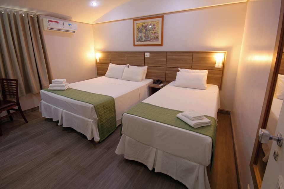 Family Triple Room | Minibar, blackout drapes, free WiFi, bed sheets