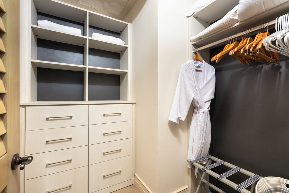 Spacious guest closet with built-in storage and thoughtful organization.