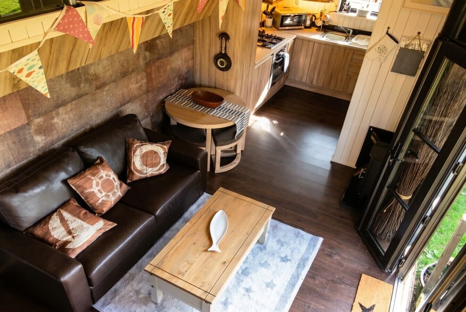 Looking down over the nautical living space into the well-stocked kitchen.