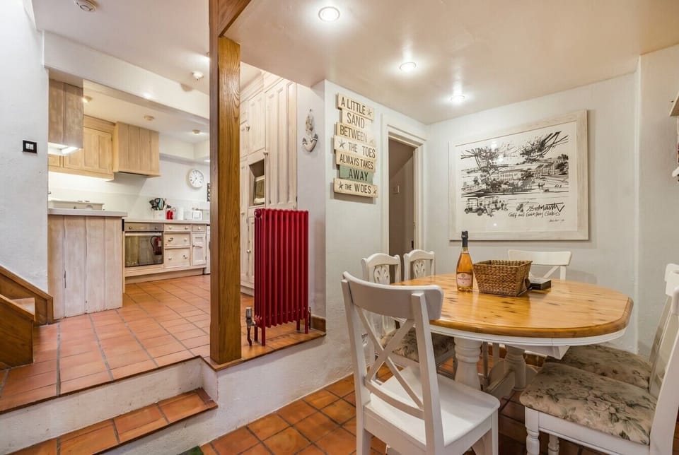 Dining nook beside the kitchen with playful seaside wall art