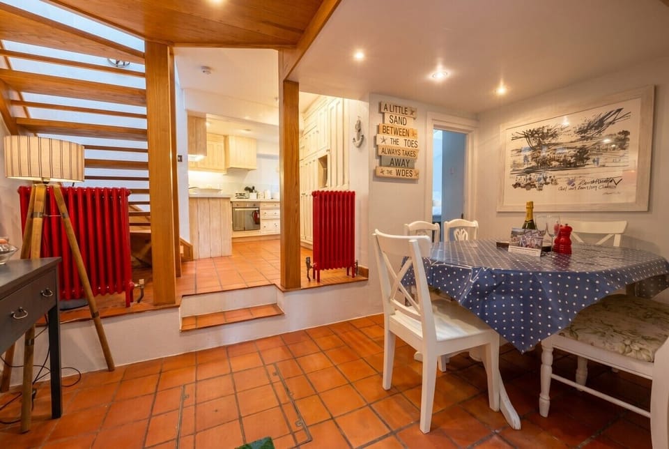 Open dining and kitchen with a glass of fizz to start the holiday