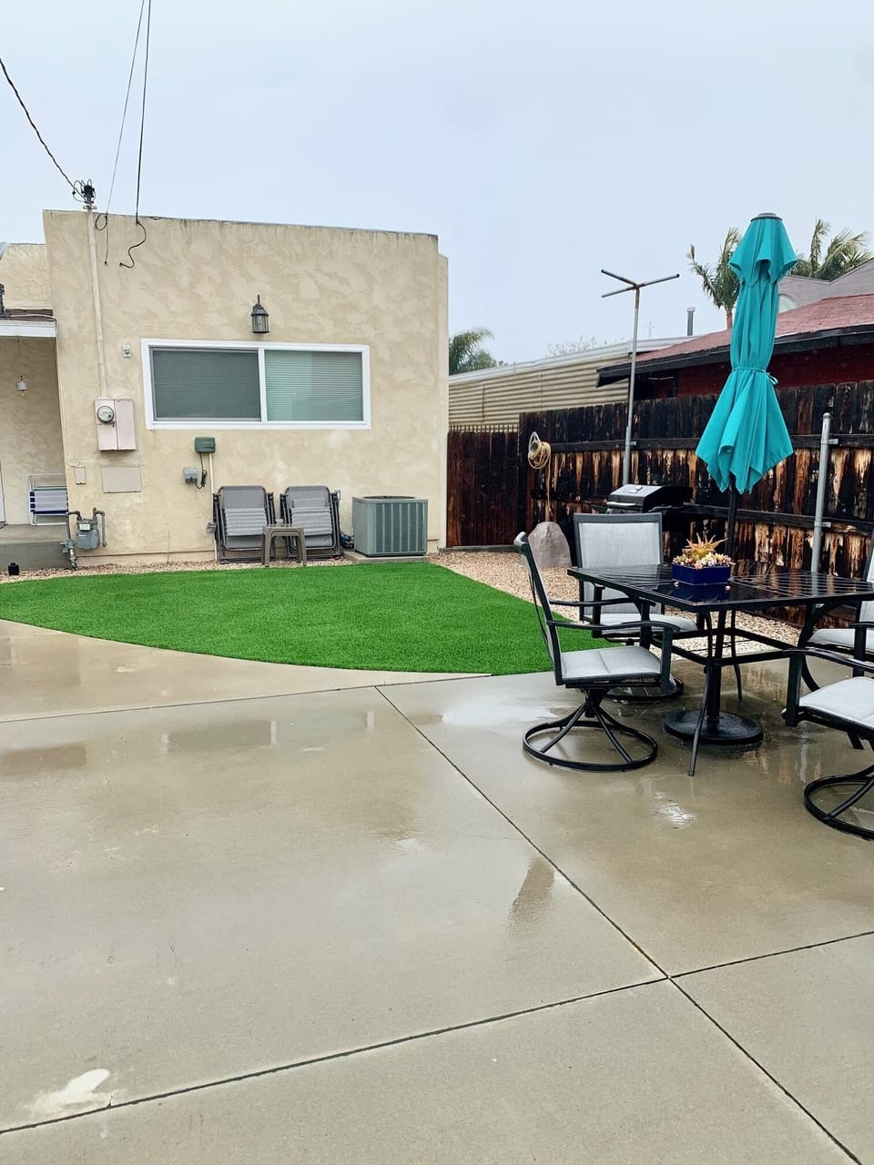 Fully fenced back patio with table/chairs, loungers, propane BBQ. Kids love it!