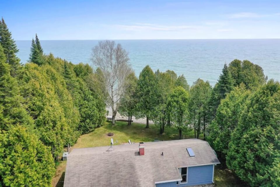 Secluded Door County lakefront cabin surrounded by trees and Lake Michigan views