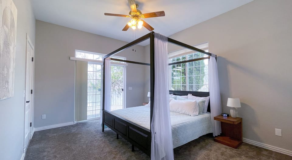 Bedroom 1: primary with direct access to backyard & view of the lake, ensuite