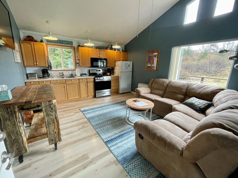 Full kitchen and large sectional with Smart TV